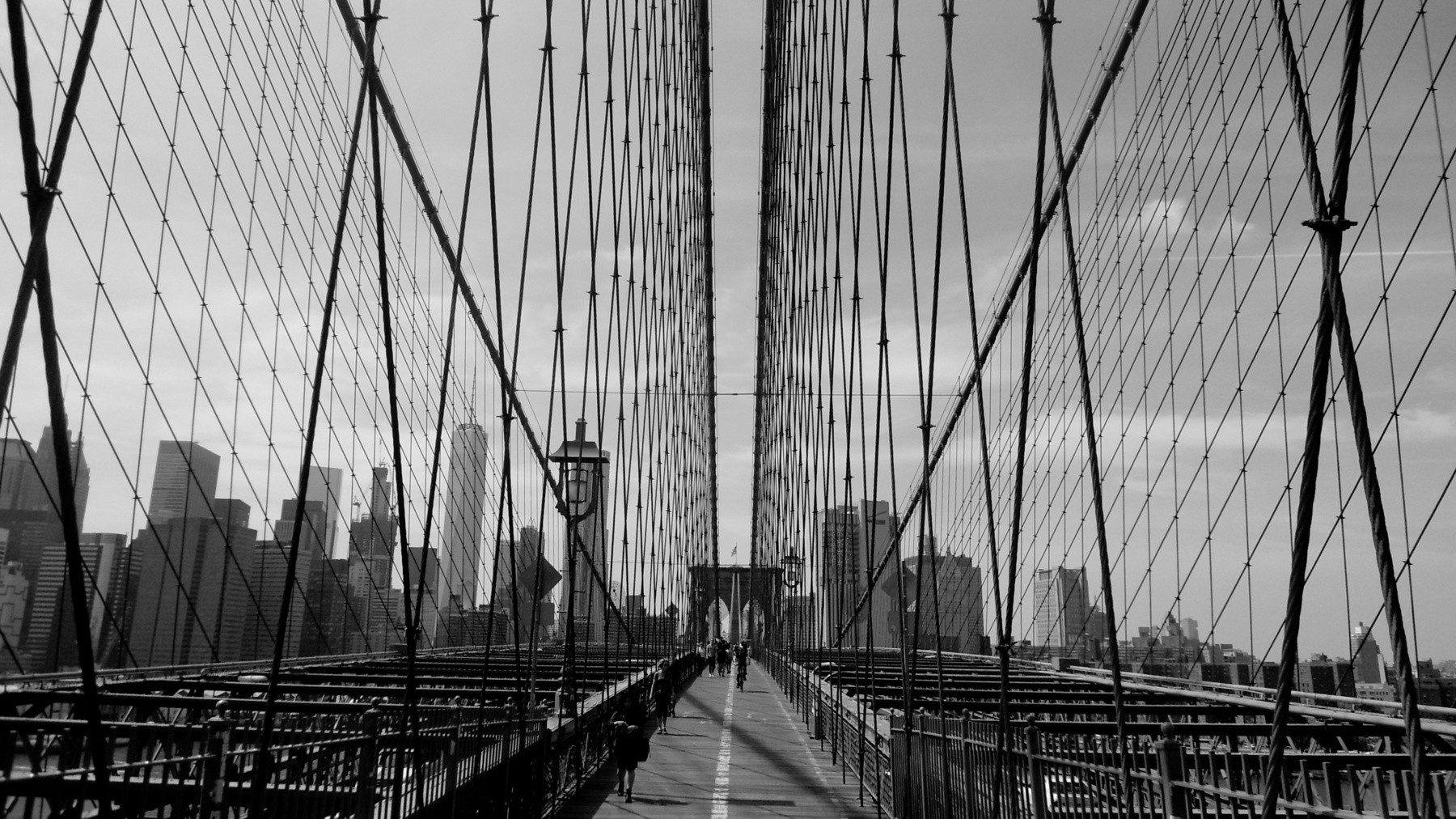 black and white photo on the middle of the brooklyn bridge