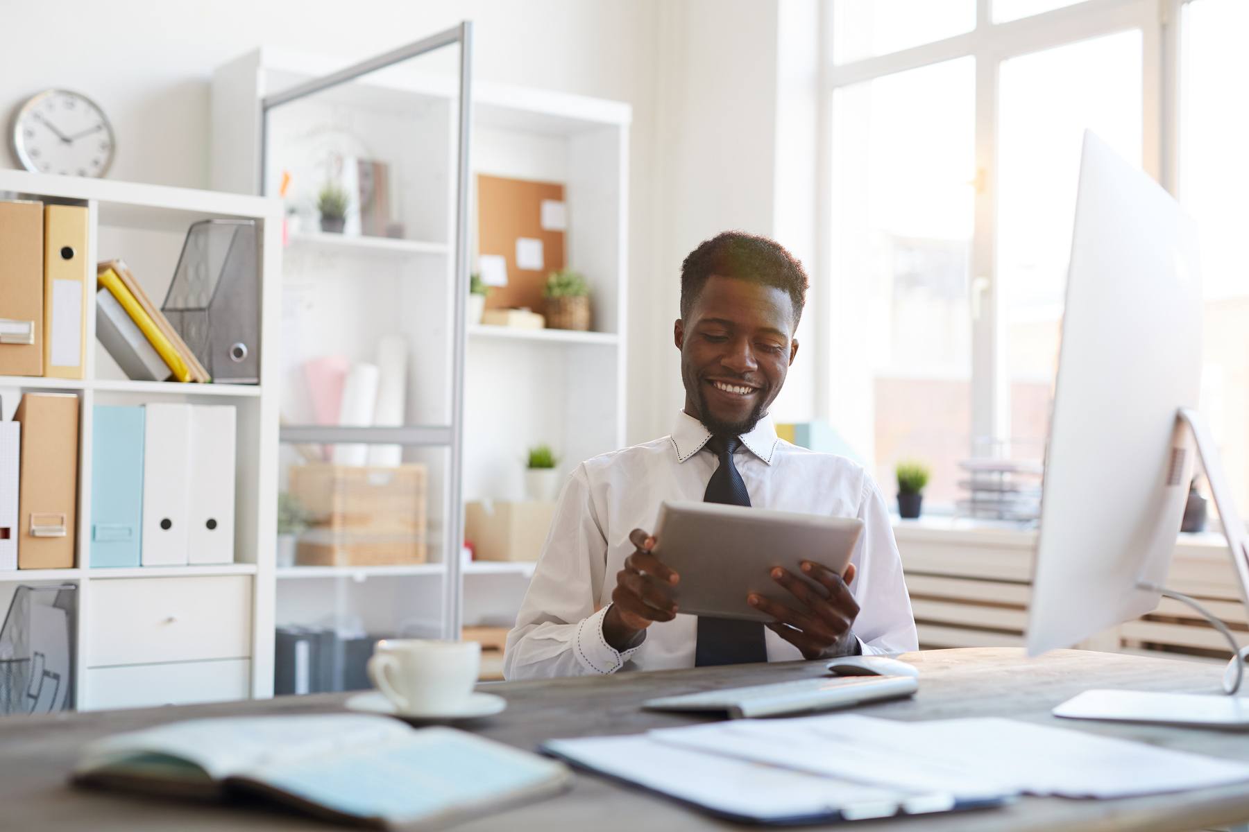 businessman laughing at his digital tablet