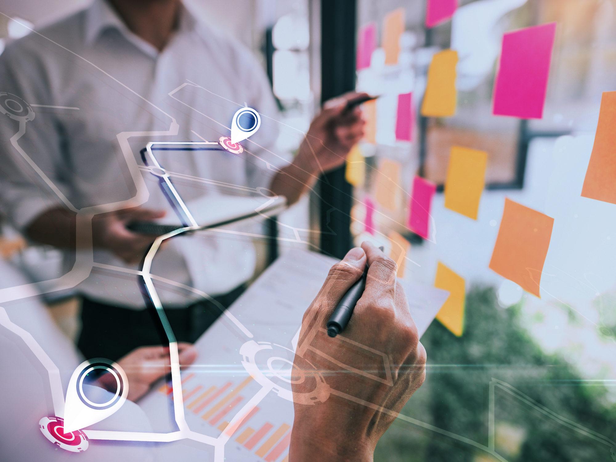 Business people meeting at office and use sticky notes on glass