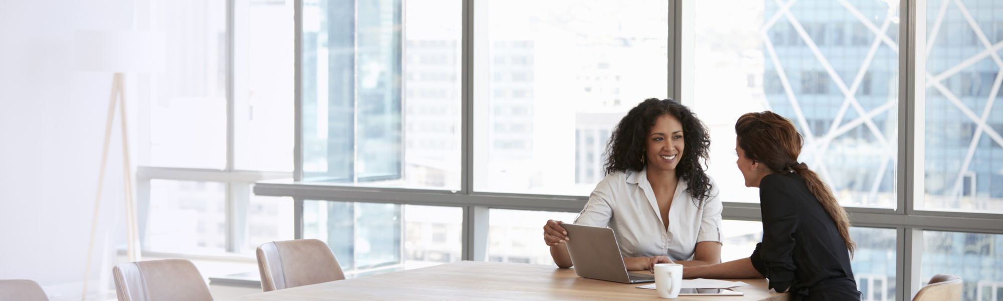 business women having a one on one in conference room