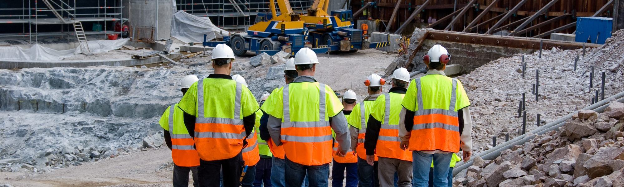 construction workers walking into construction site