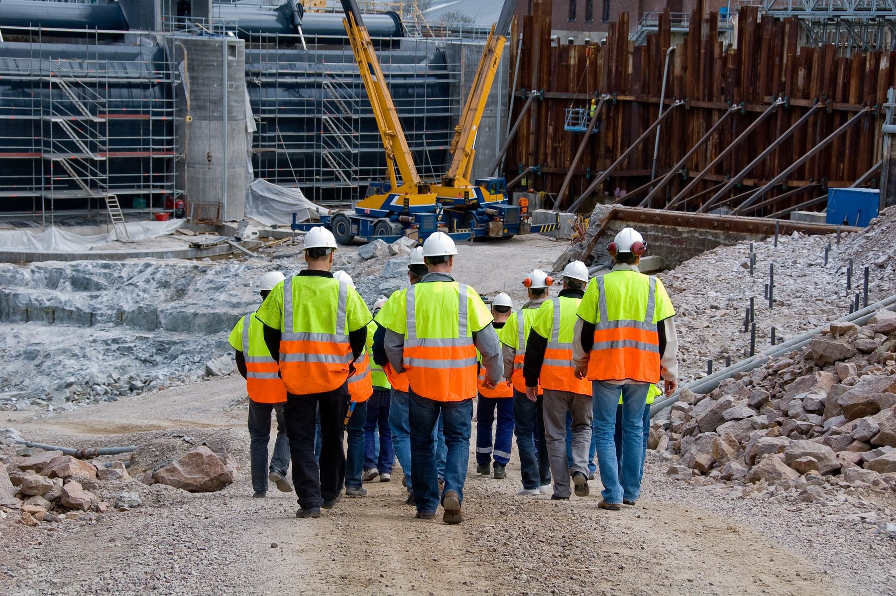 construction workers walking into construction site