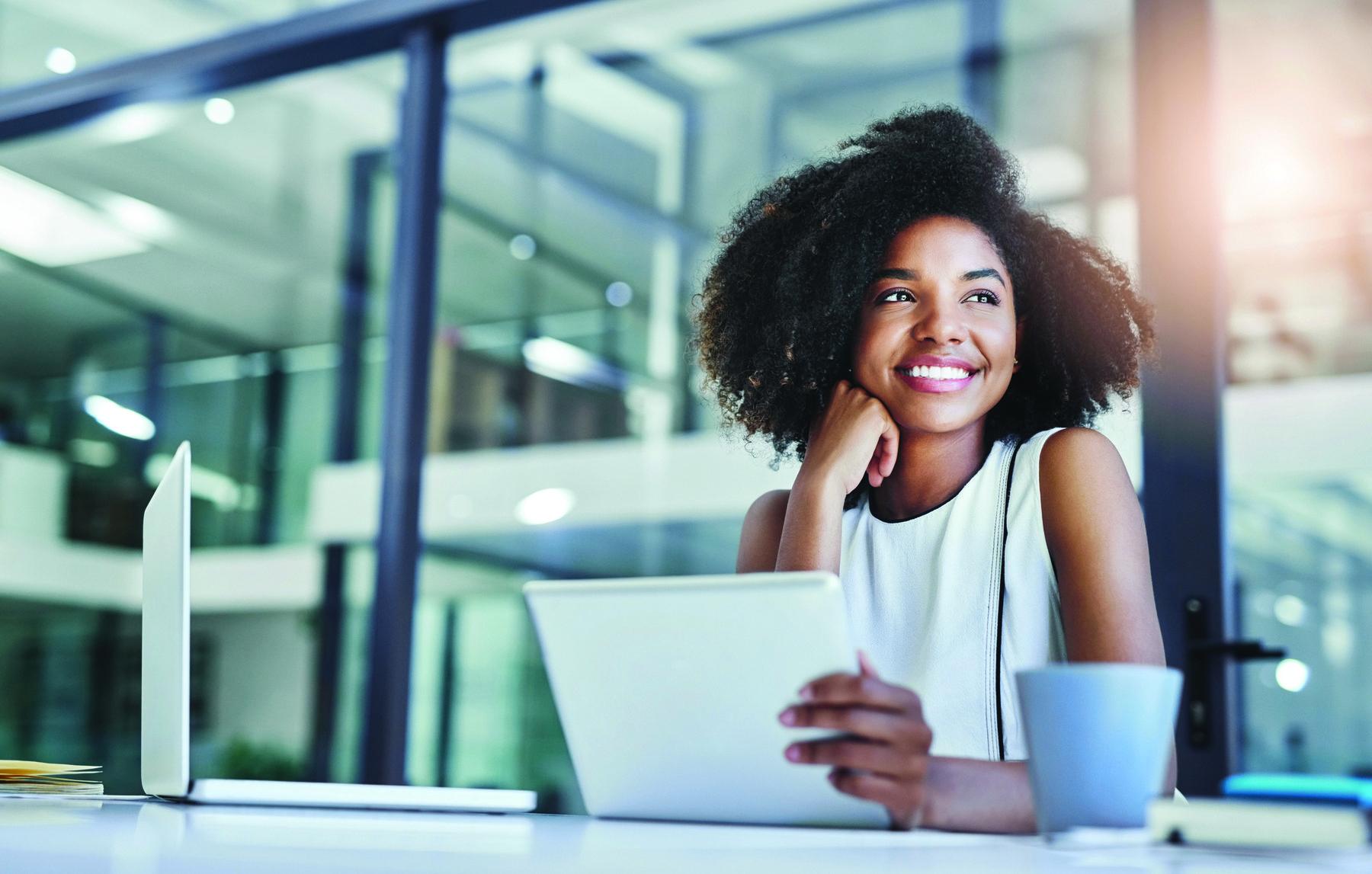 smiling businesswoman with digital tablet in her hand