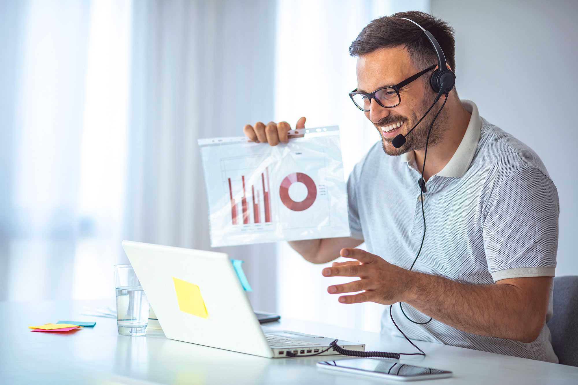 man with headset presenting information during virtual meeting