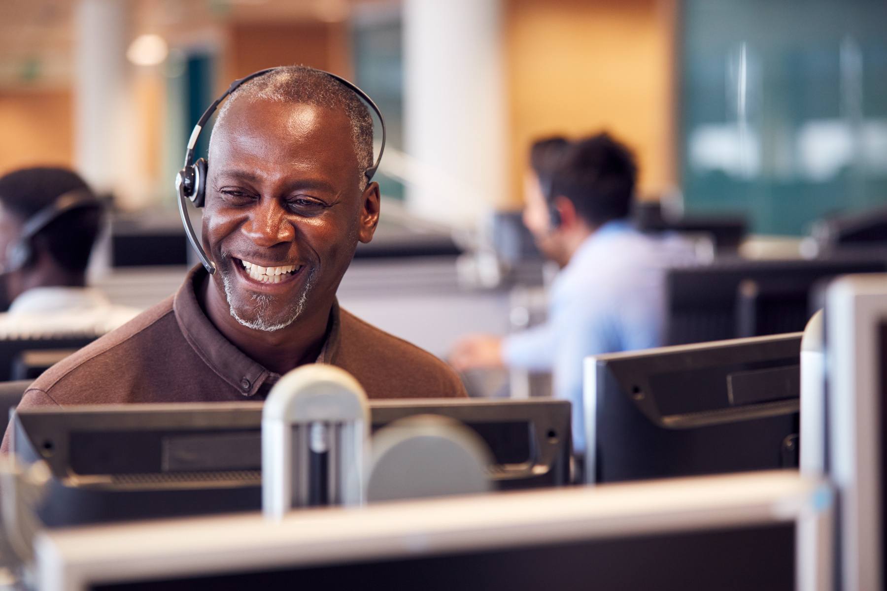smiling man with headset in call center