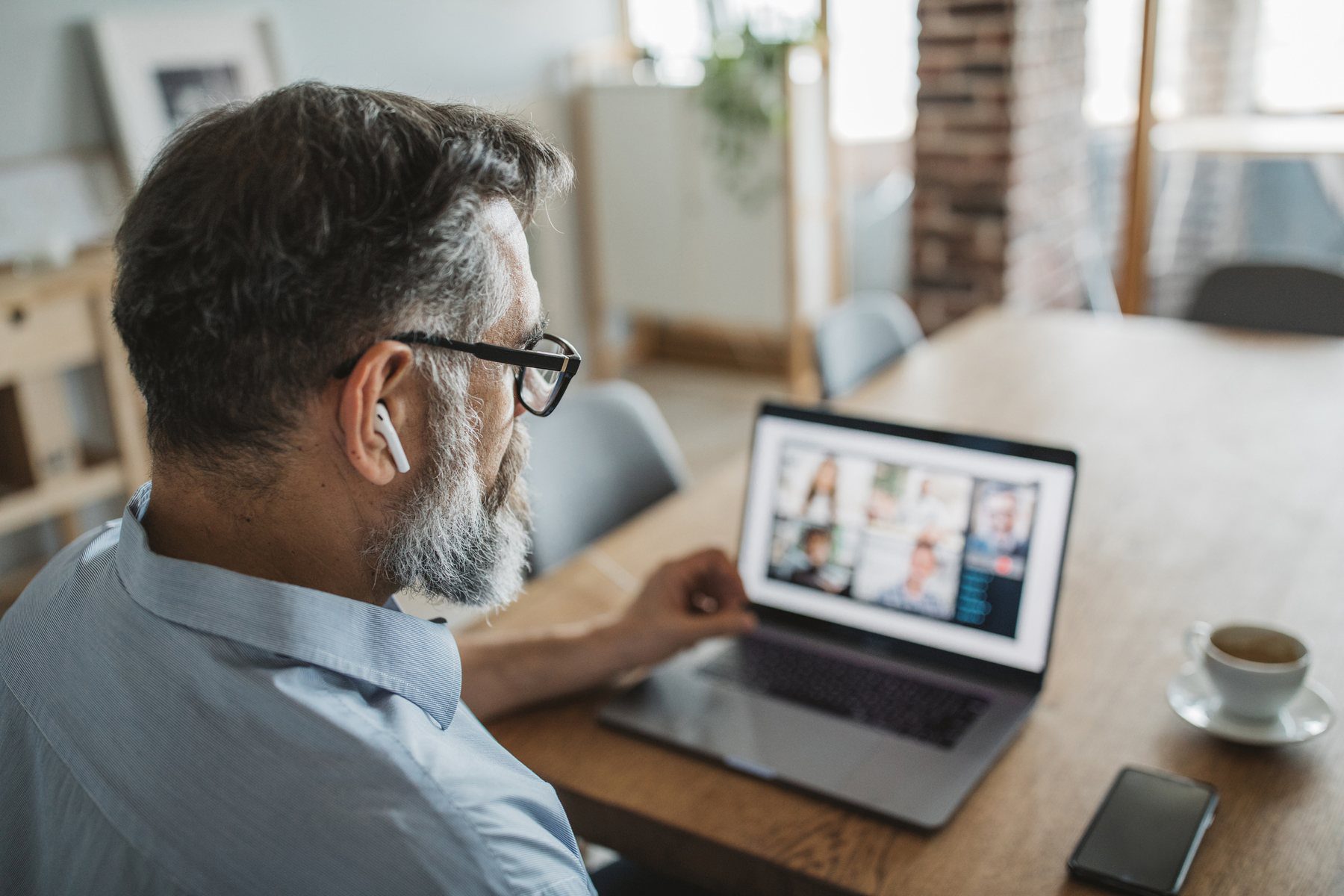 man on video conference call on his laptop