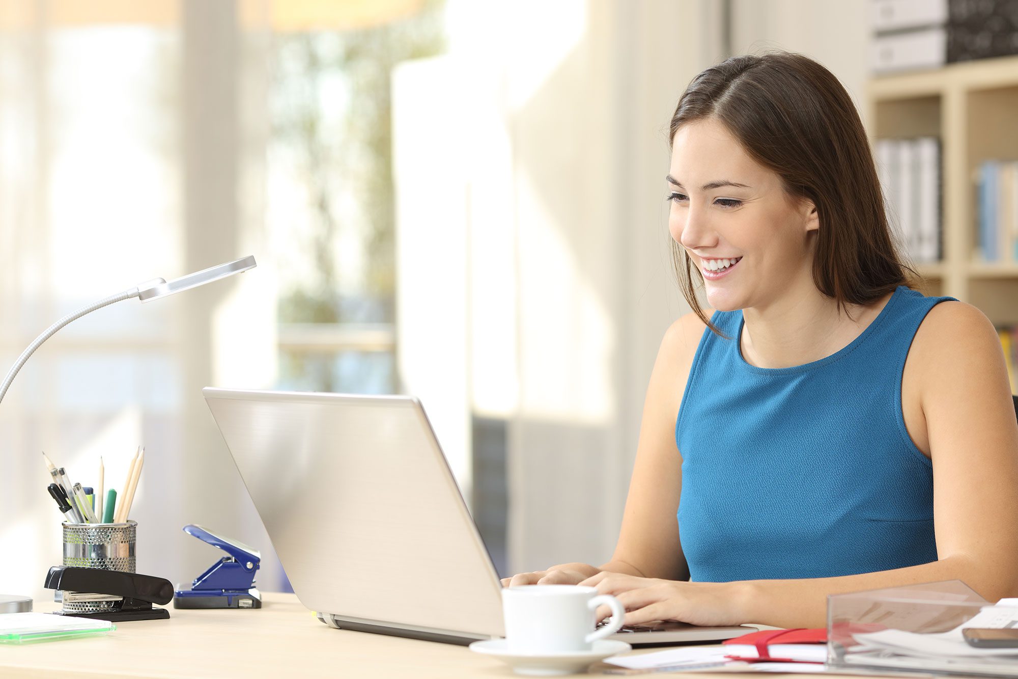 smiling woman working on her laptop