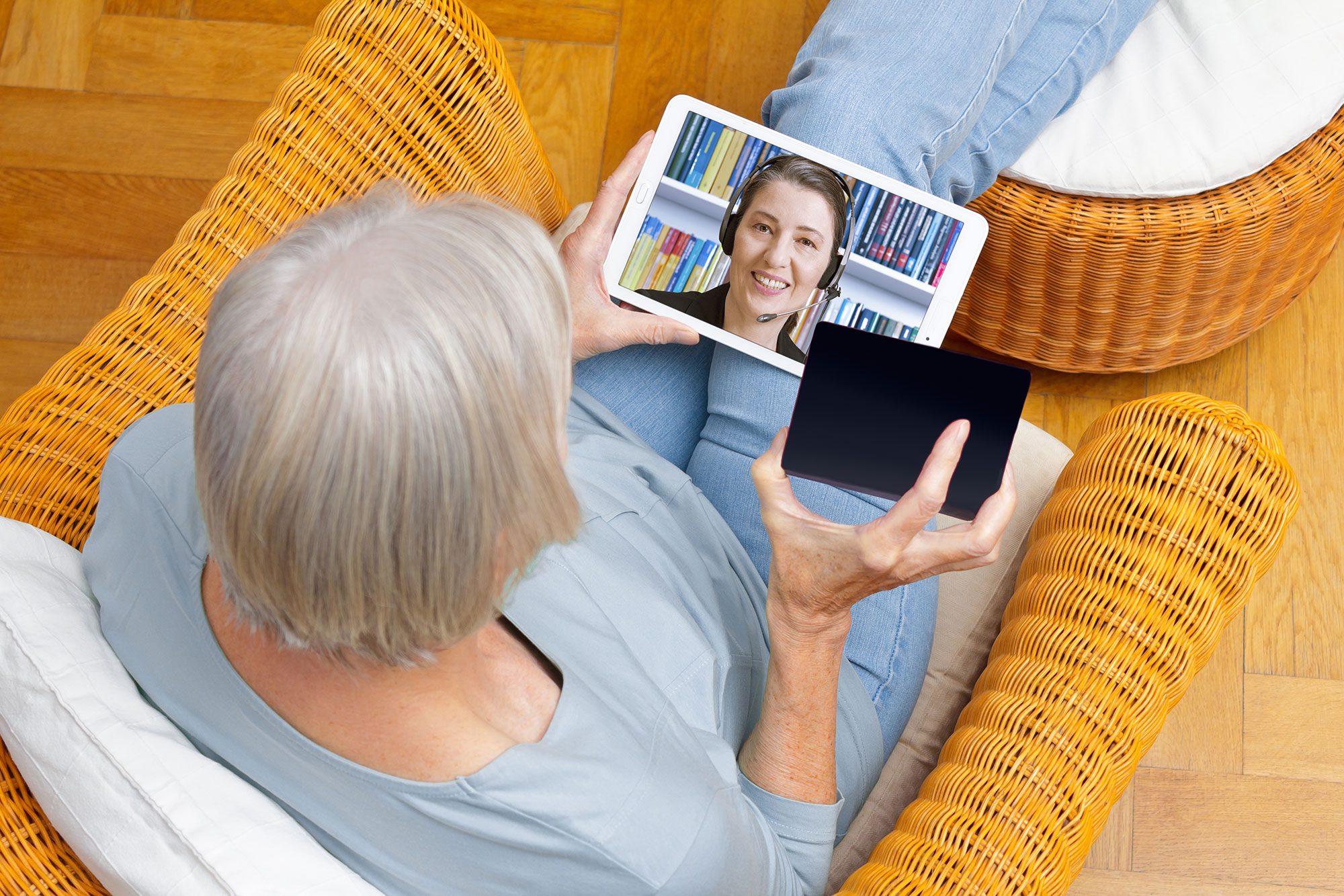 overhead view of old woman on video call with customer support