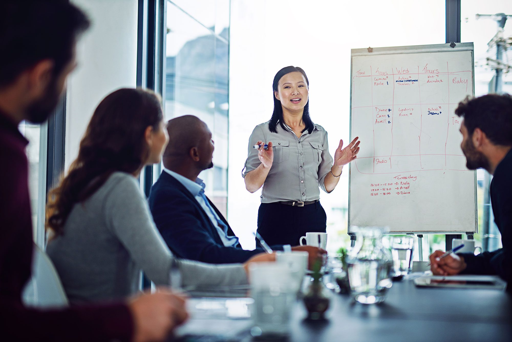 A woman giving a presentation to her team