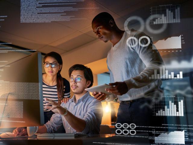 Computer programmers looking through data in the office