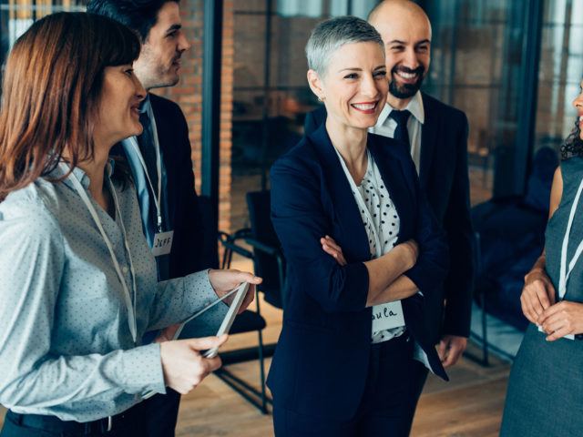 business people standing and smiling