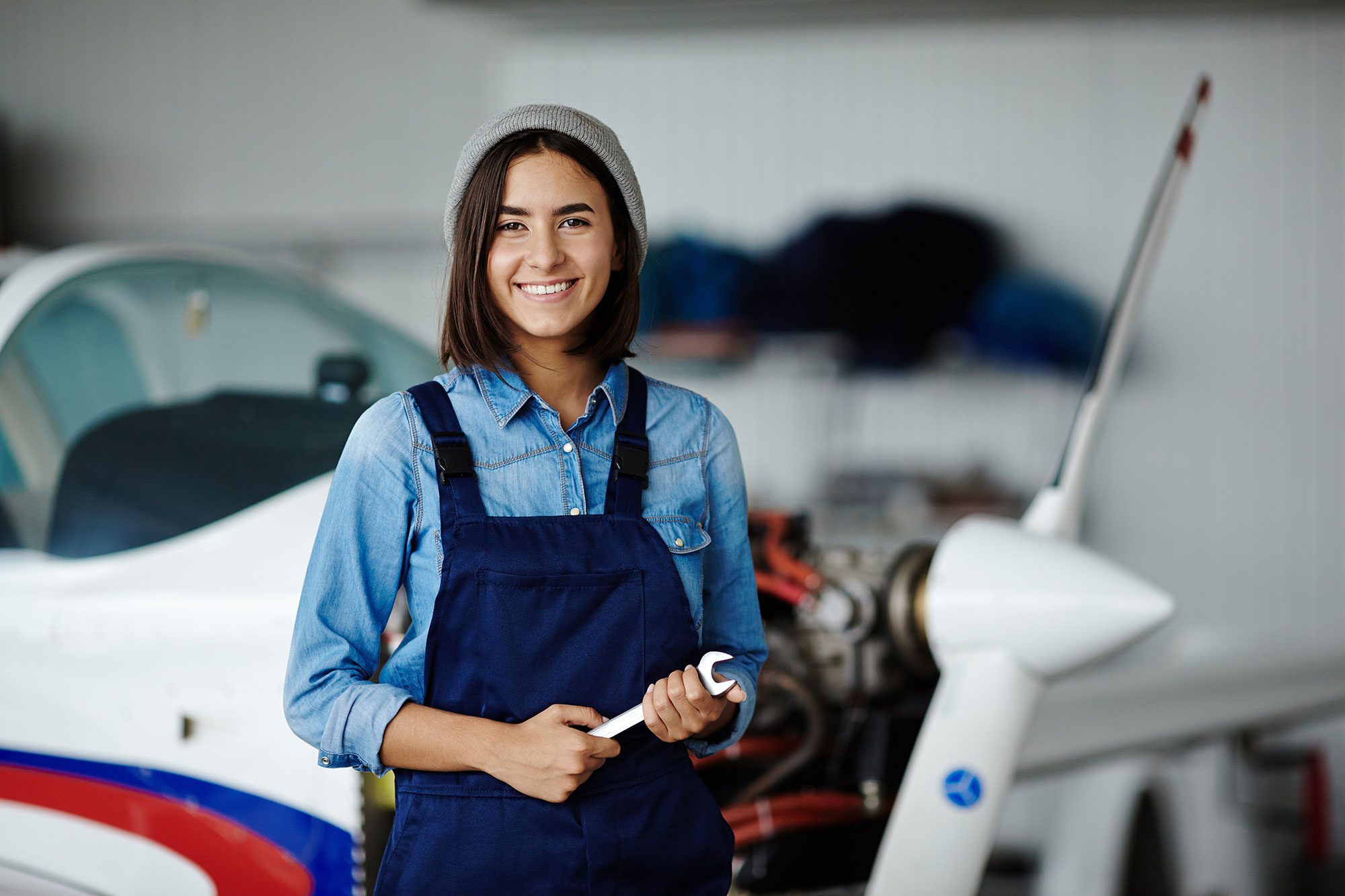 Happy worker of engineering service looking at camera