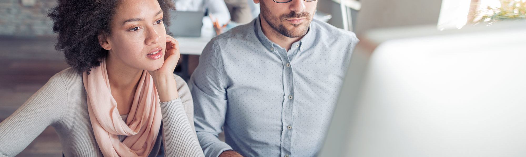 businessman and businesswoman looking at information on a computer