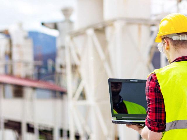 energy back of worker looking at laptop