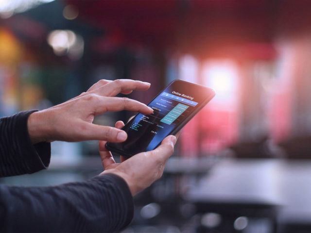 person tapping their phone screen