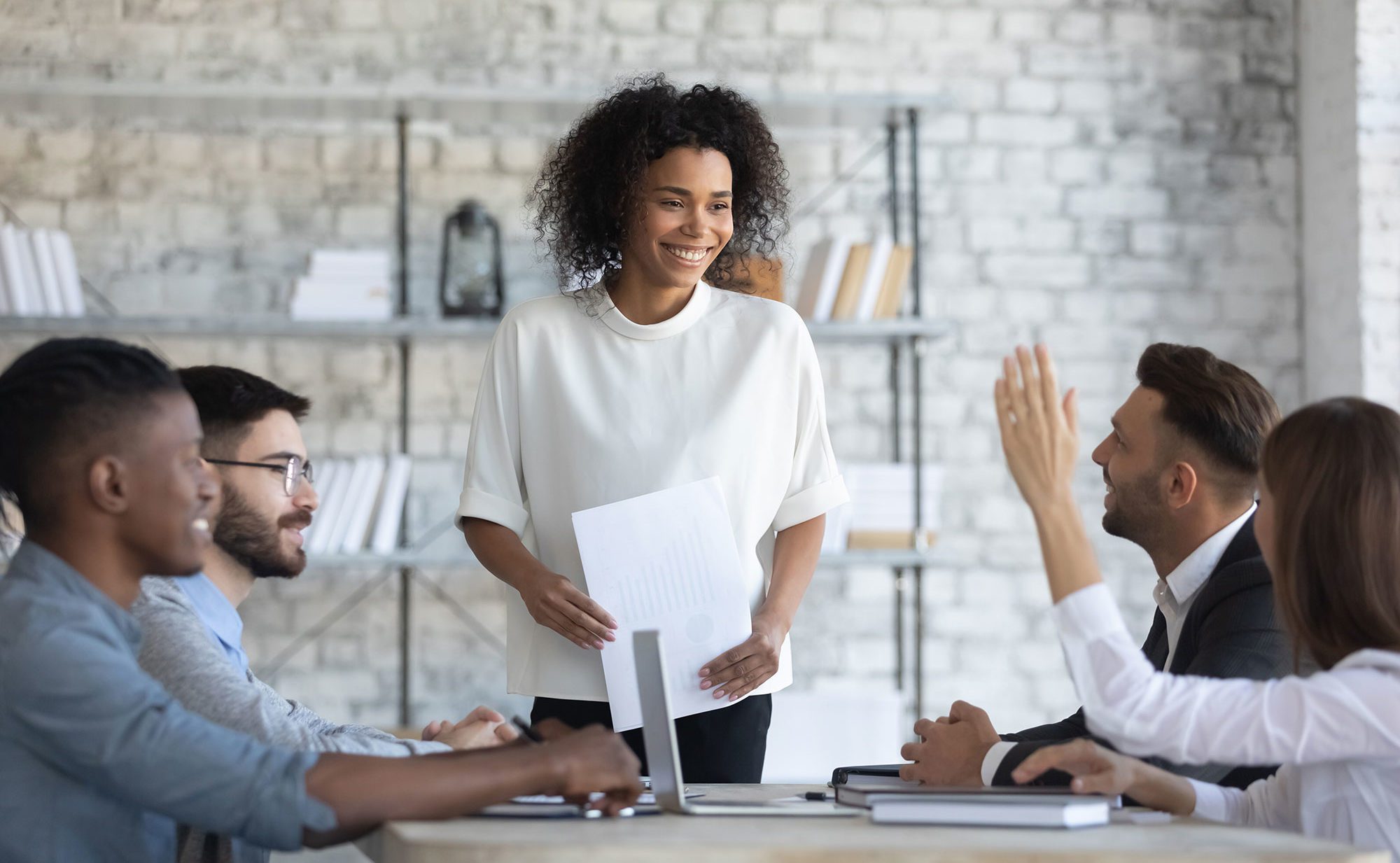 Woman standing and leading business meeting