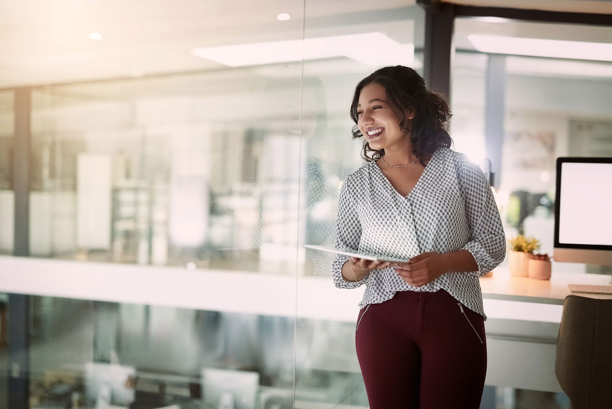 businesswoman smiling with digital tablet in her hand