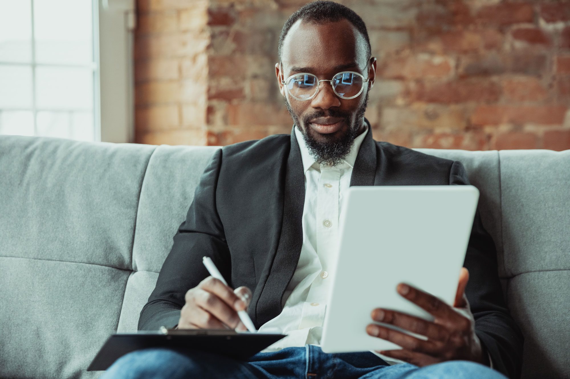 African-american businessman using laptop, tablet