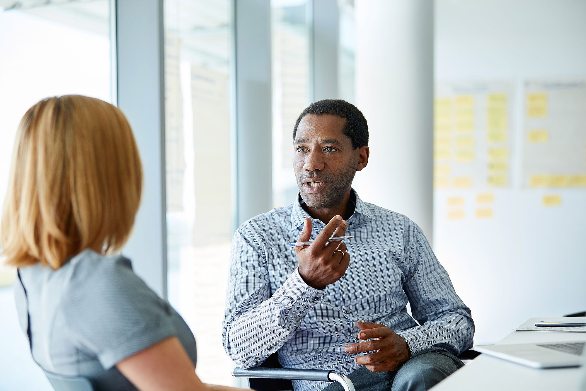 African American male in a business meeting with female business partner