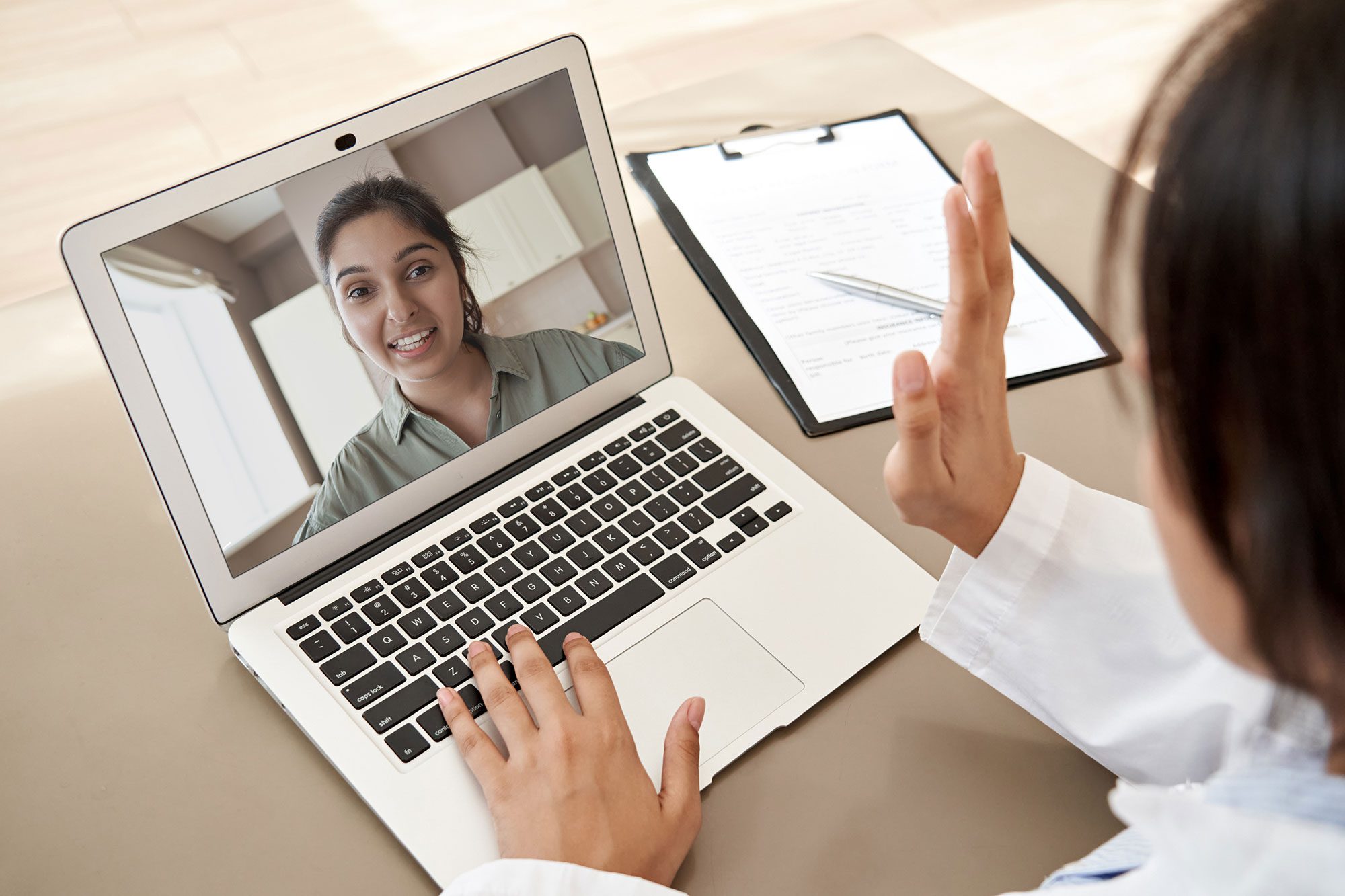 two people having a video chat on a laptop