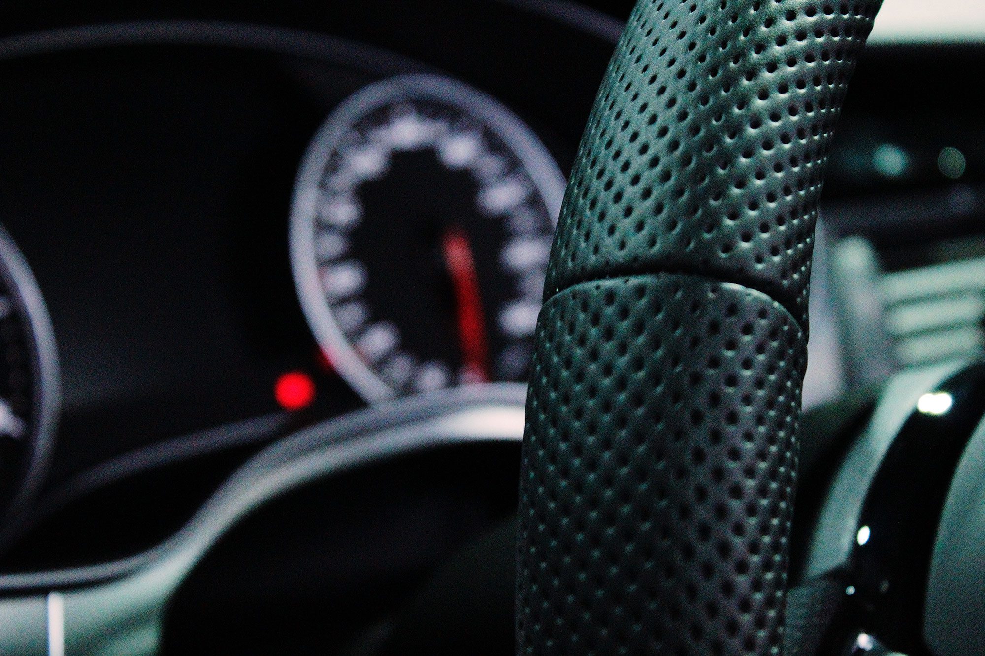 Closeup of interior of steering wheel and dashboard inside vehicle