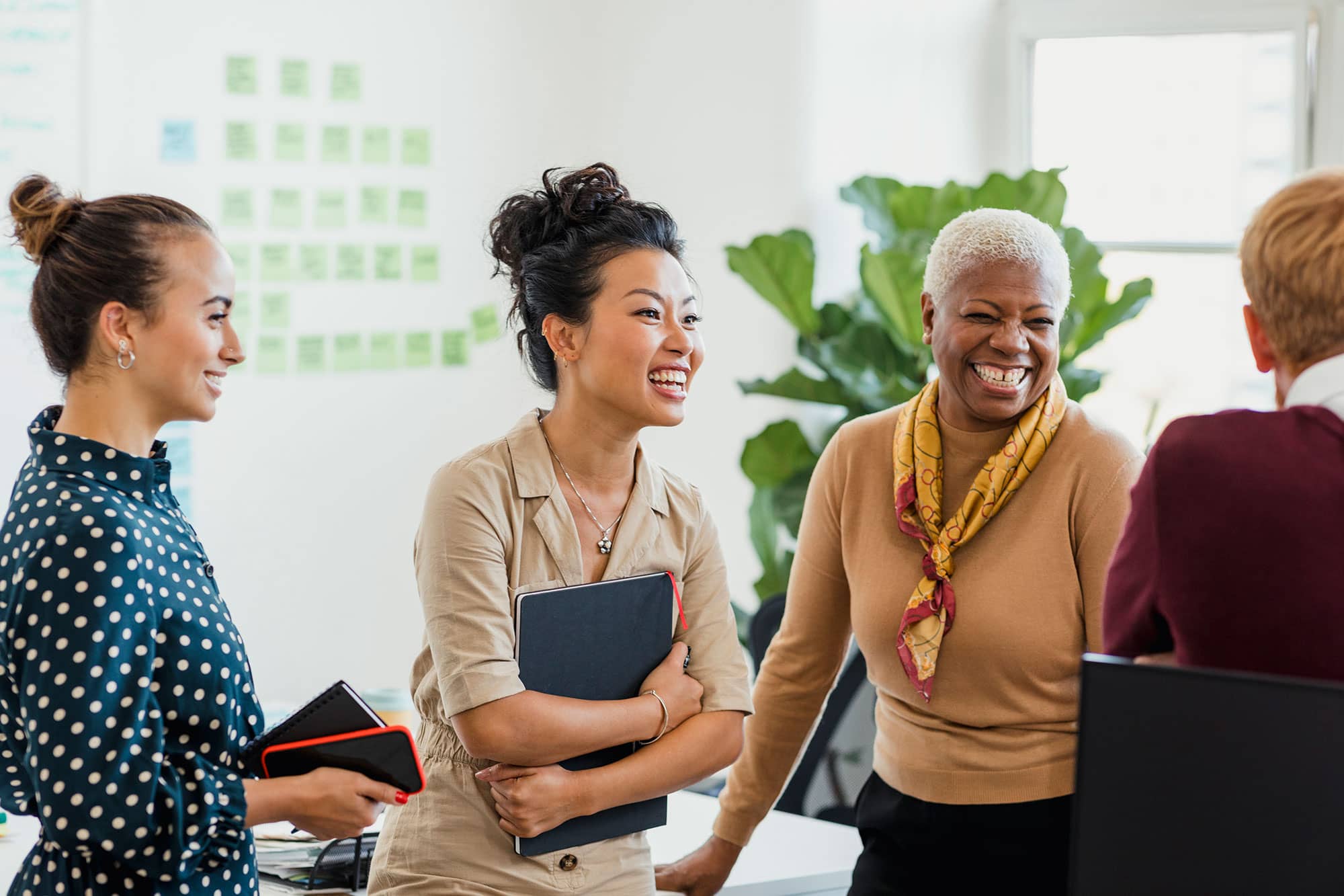 Teamwork | Group of diverse coworkers having a happy conversation